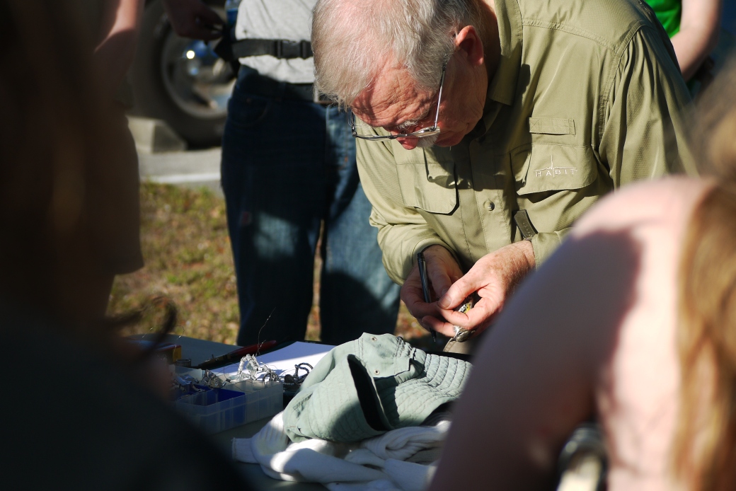 Jerry Jackson in the process of ringing a Yellow Rumped Warbler.